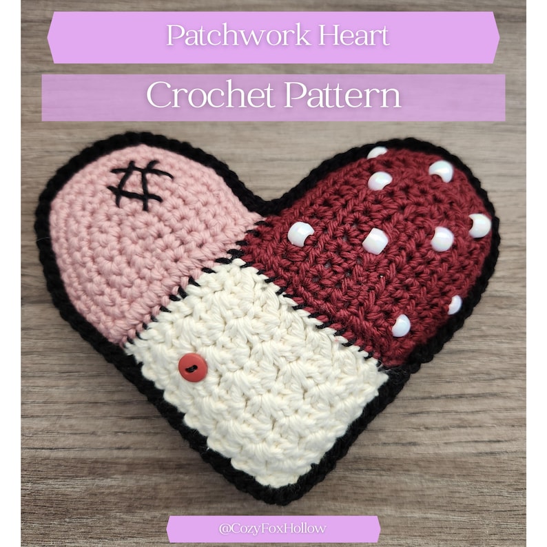 May include: A handmade crochet heart with a patchwork design. The heart is divided into three sections: light pink, cream, and burgundy with white dots. The heart has a black border, a red button, and the text "Patchwork Heart Crochet Pattern".