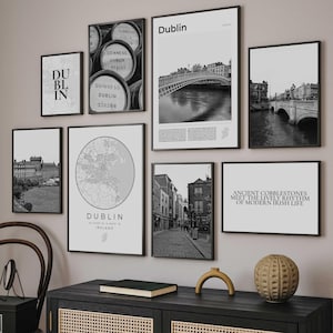 May include: A collection of framed black and white prints featuring Dublin, Ireland. The prints include images of the city's architecture, bridges, and a map, along with text that reads "Dublin" and "Ancient Cobblestones Meet the Lively Rhythm of Modern Irish Life."