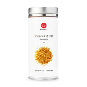 May include: A cylindrical white metal container of Sobacha buckwheat tea. The container has a silver lid and base. The label features the text "SENBIRDTEA", "SOBACHA そば茶 Buckwheat Tea Aji", and a red logo. A pile of golden buckwheat tea is visible.
