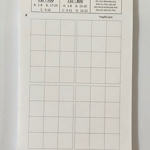 May include: A white paper with a grid pattern, featuring text for 737-700 and 737-800 aircraft, including seat numbers and airport codes. The website TrayPal.com is also visible.