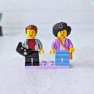 A pair of mini figures with accessories