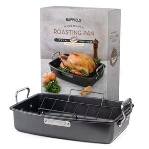 May include: A dark gray roasting pan with a rack, and a box that reads "HAPPELS PREMIUM ROASTING PAN 17 X 13 IN". The pan has silver handles and a metal tag that reads "HAPPIELS". A cooked turkey is in a similar pan in the background.