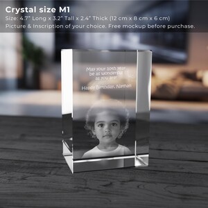 May include: A clear glass cube with a photo of a young child and a personalized inscription. The inscription reads "May your 10th year be as wonderful as you are! Happy Birthday, Nathan". The cube measures 4.7 inches long, 3.2 inches tall, and 2.4 inches thick.