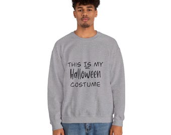 May include: A gray sweatshirt with the text "THIS IS MY Halloween COSTUME" in black. The sweatshirt is a crew neck style and is being worn by a person. The text is centered on the front of the shirt.