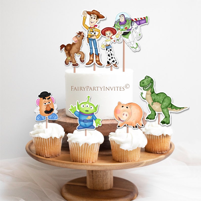 May include: Toy Story themed cupcake toppers featuring characters like Woody, Buzz Lightyear, Jessie, Rex, and Hamm. The toppers are printed on cardstock and attached to wooden skewers.  FairyPartyInvites is printed on the cake.