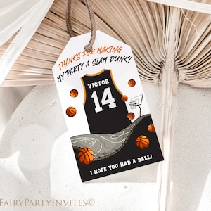 May include: A white thank you tag with orange text that reads 