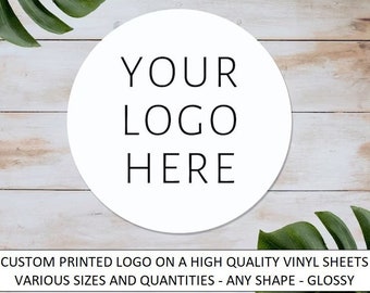 May include: White circle with the text "YOUR LOGO HERE" on a wood background.  Custom printed logo on a high quality vinyl sheet. Various sizes and quantities - any shape - glossy.