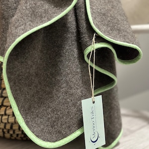 High quality handmade light brown and mint dotted cotton edge natural sheep and alpaca wool blanket made in Lithuania for baby.