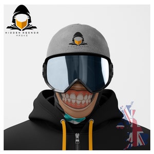 May include: A black hooded figure with a yellow mask, the text "HIDDEN AGENDA MASKS" is above the figure. A person is wearing a grey beanie with the same logo on it, a black ski mask with a cartoon face and a large toothy grin, and a black hoodie with a yellow zipper pull.