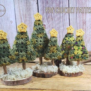 May include: A set of six crocheted Christmas trees in various sizes, with green and yellow yarn, standing on wooden bases with moss. The trees are decorated with small yellow beads. The image includes the text "PDF CROCHET PATTERN".