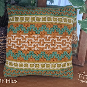 May include: A square, crocheted pillow with a geometric pattern in shades of orange, teal, and cream. The pillow features a mosaic crochet design with the text "PDF Files" at the bottom left and "Mosaic crochet" at the bottom right.