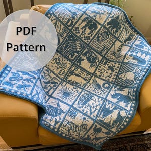 May include: A blue and white knitted blanket with a pattern of animals and letters. The blanket is folded and sitting on a yellow sofa. The text "PDF Pattern" is written on a white circle in the top left corner of the image.