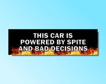 May include: Black and orange car bumper sticker with the text "This car is powered by spite and bad decisions".