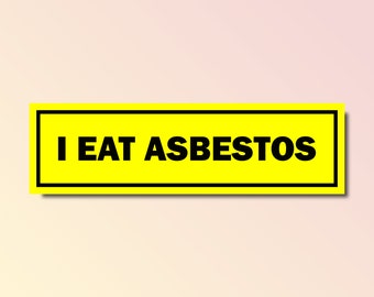 May include: A rectangular yellow sticker with a black border and the words "I EAT ASBESTOS" in bold black letters. The background is a gradient of light pink and white.