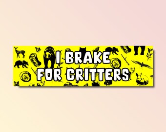 May include: Yellow bumper sticker with black silhouettes of various animals and the text "I Brake For Critters".