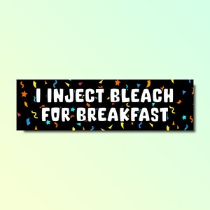 May include: Black bumper sticker with colourful confetti and the text "I inject bleach for breakfast".