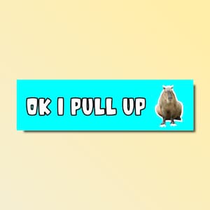 May include: A rectangular sticker with the text "OK I PULL UP" in white, outlined in black, on a bright blue background. A cartoon capybara is on the right. The background is a gradient of yellow and light yellow.