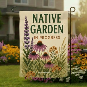 May include: A rectangular garden flag with a cream background featuring the dark green text NATIVE GARDEN and the brown text IN PROGRESS. The design includes illustrations of purple coneflowers, tall purple spikes, and small yellow wildflowers.