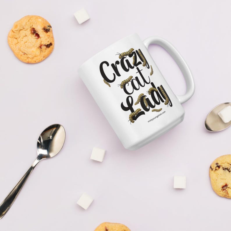 Crazy Cat Lady Mug, Monarch Caterpillar Coffee Mug, Funny Nature Pun Mug, Butterfly Lover Mug, Double Sided Ceramic Mug  Glossy ceramic coffee mug featuring a double sided design with the text Crazy Cat Lady surrounded by monarch caterpillars, playful nature pun artwork for butterfly enthusiasts and gardeners, ceramic coffee mug available in 11 oz 15 oz and 20 oz sizes, dishwasher and microwave safe