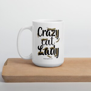 Crazy Cat Lady Mug, Monarch Caterpillar Coffee Mug, Funny Nature Pun Mug, Butterfly Lover Mug, Double Sided Ceramic Mug Glossy ceramic coffee mug featuring a double sided design with the text Crazy Cat Lady surrounded by monarch caterpillars, playful nature pun artwork for butterfly enthusiasts and gardeners, ceramic coffee mug available in 11 oz 15 oz and 20 oz sizes, dishwasher and microwave safe