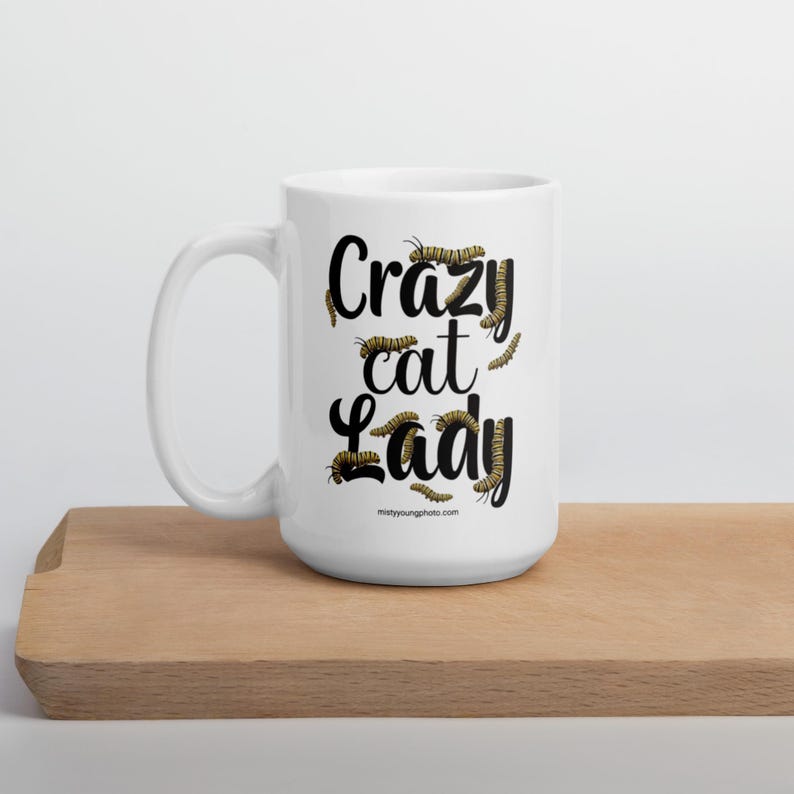 Crazy Cat Lady Mug, Monarch Caterpillar Coffee Mug, Funny Nature Pun Mug, Butterfly Lover Mug, Double Sided Ceramic Mug Glossy ceramic coffee mug featuring a double sided design with the text Crazy Cat Lady surrounded by monarch caterpillars, playful nature pun artwork for butterfly enthusiasts and gardeners, ceramic coffee mug available in 11 oz 15 oz and 20 oz sizes, dishwasher and microwave safe