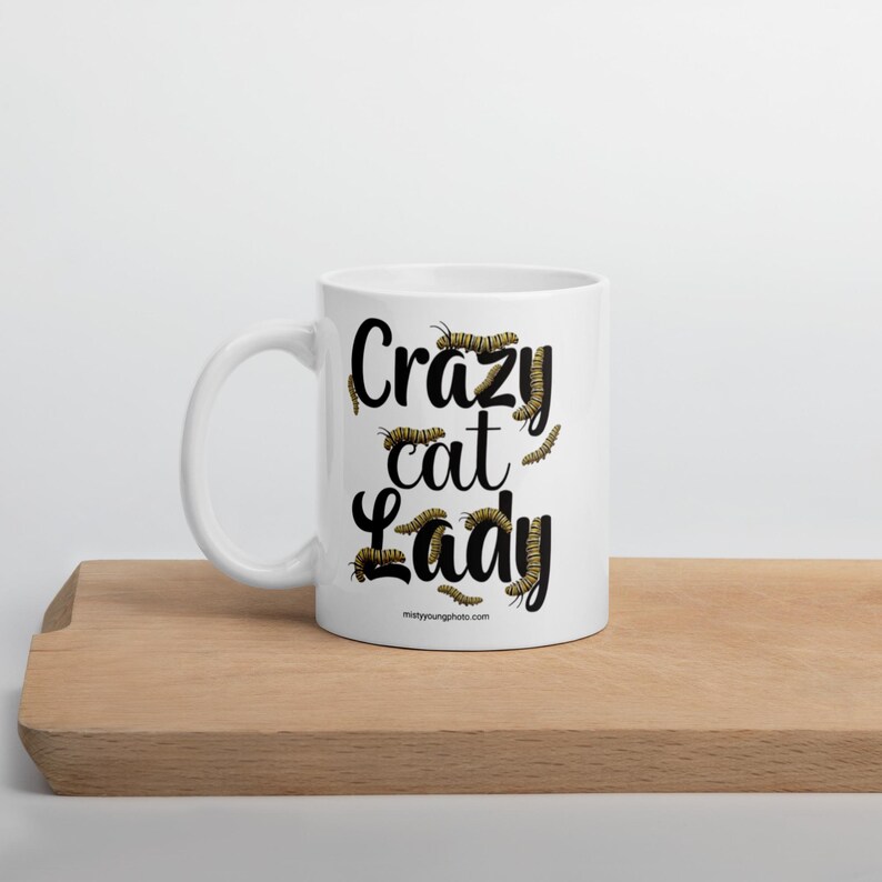 Crazy Cat Lady Mug, Monarch Caterpillar Coffee Mug, Funny Nature Pun Mug, Butterfly Lover Mug, Double Sided Ceramic Mug  Glossy ceramic coffee mug featuring a double sided design with the text Crazy Cat Lady surrounded by monarch caterpillars, playful nature pun artwork for butterfly enthusiasts and gardeners, ceramic coffee mug available in 11 oz 15 oz and 20 oz sizes, dishwasher and microwave safe