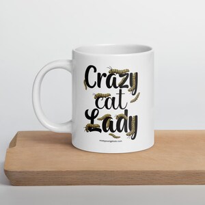 Crazy Cat Lady Mug, Monarch Caterpillar Coffee Mug, Funny Nature Pun Mug, Butterfly Lover Mug, Double Sided Ceramic Mug  Glossy ceramic coffee mug featuring a double sided design with the text Crazy Cat Lady surrounded by monarch caterpillars, playful nature pun artwork for butterfly enthusiasts and gardeners, ceramic coffee mug available in 11 oz 15 oz and 20 oz sizes, dishwasher and microwave safe