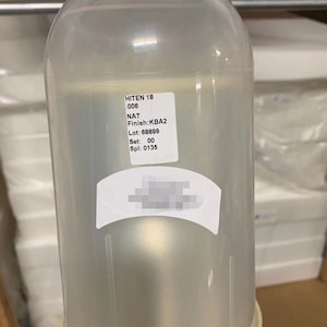 May include: A clear plastic bottle with a white label that reads "HITEN 18 006 NAT Finish: KBA2 Lot: 68899 Set: 00 Spl: 0135".