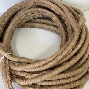 May include: A roll of brown burlap rope, perfect for crafting or decorating.