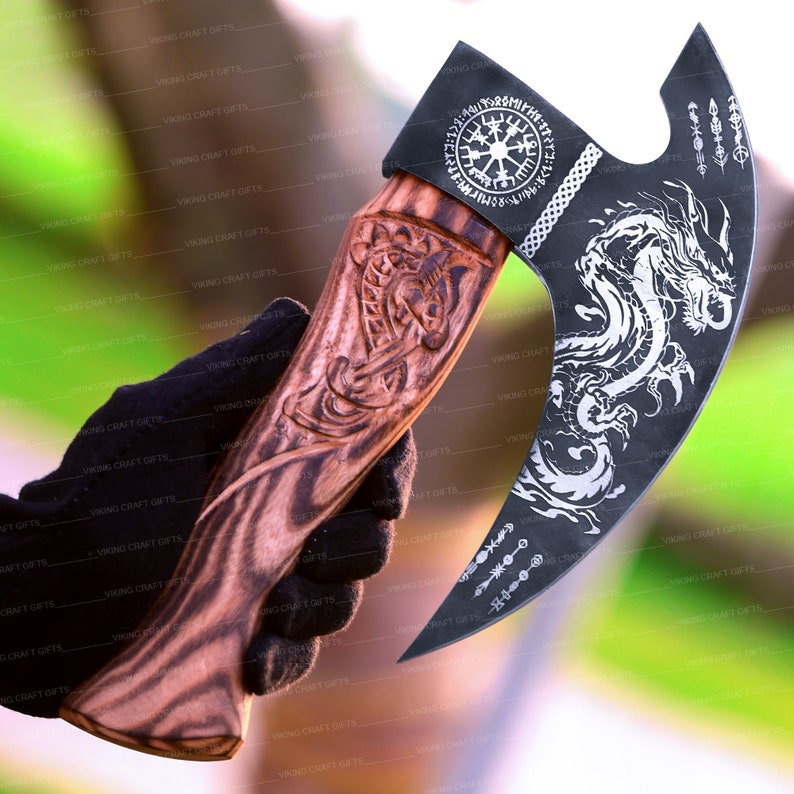 May include: A black axe with a wooden handle. The axe head has a dragon design and a circular design with runes. The handle is carved with a knotwork design.