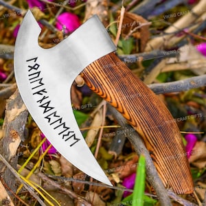 May include: A silver axe with a wooden handle. The axe head has a curved blade with a runic inscription. The handle is made of dark wood with a grain pattern.