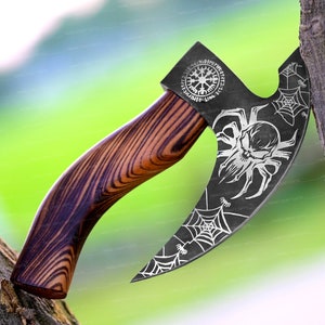 May include: A black axe with a wooden handle. The axe head has a spider web design with a skull in the center. The handle is made of dark wood with a grain pattern. The axe head also has a circular design with runes around the edge.