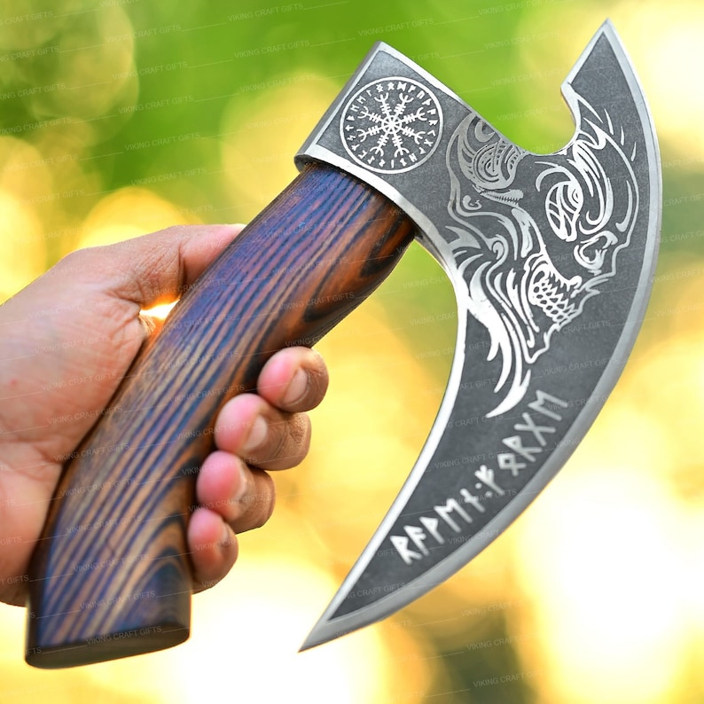 May include: A silver axe with a wooden handle. The axe head has a decorative design with a dragon and runes. The runes read "R&Auml;PM:T:RXM".