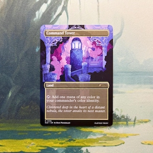 May include: A rectangular trading card titled Command Tower featuring a purple and blue illustration of a stone tower surrounded by clouds. The card text reads: Add one mana of any color in your commander's color identity. Cloistered deep in the heart of a distant nebula, the tower awaits its next master.