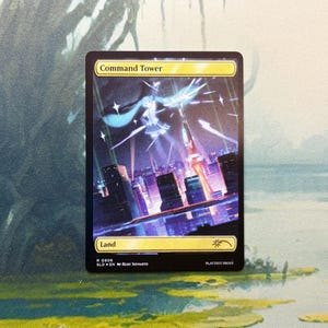 May include: A rectangular Magic: The Gathering trading card titled Command Tower, featuring a vibrant illustration of a stylized character performing above a futuristic city skyline at night with purple and blue lighting effects and star accents.