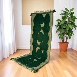 Extra-long Moroccan runner rug in deep green with bold organic patterns and beige wool base. This handcrafted Beni Ourain wool carpet is perfect for hallways, corridors, and modern interiors needing a unique, earthy touch. Made by Berber artisans using natural wool, it combines luxury softness and geometric structure. Ideal for minimalist, boho, or Japandi-style homes.