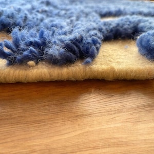 A vintage Moroccan wool rug with a bold blue abstract design handwoven on a neutral beige background, featuring plush texture and traditional fringed edges Vintage Rug, Moroccan Rug Wool Rug Abstract Rug Handwoven Rug Blue Rug Bold Design Modern Rug