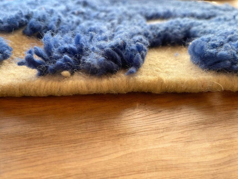 A vintage Moroccan wool rug with a bold blue abstract design handwoven on a neutral beige background, featuring plush texture and traditional fringed edges Vintage Rug, Moroccan Rug Wool Rug Abstract Rug Handwoven Rug Blue Rug Bold Design Modern Rug
