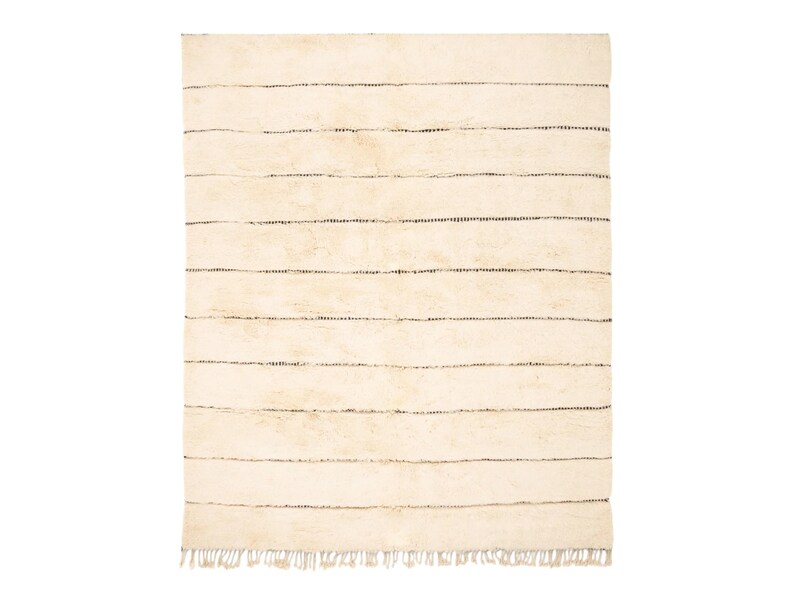 Handmade Moroccan rug with minimalist horizontal striped design, crafted from plush wool in a warm beige tone. Soft and cozy, this rug is ideal for living rooms, bedrooms, or modern spaces. Subtle fringes add a touch of traditional elegance.