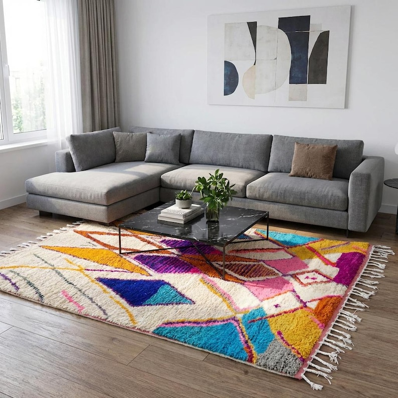Authentic handmade Moroccan Boujaad rug featuring bold geometric diamond patterns in vibrant multicolor — electric blue, fuchsia pink, orange, yellow and purple on ivory wool background. Hand-knotted by Berber artisans in Morocco using natural wool. Perfect boho statement rug for living room, bedroom or dining room. One-of-a-kind colorful area rug with traditional fringe.