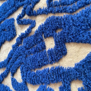 A vintage Moroccan wool rug with a bold blue abstract design handwoven on a neutral beige background, featuring plush texture and traditional fringed edges Vintage Rug, Moroccan Rug Wool Rug Abstract Rug Handwoven Rug Blue Rug Bold Design Modern Rug