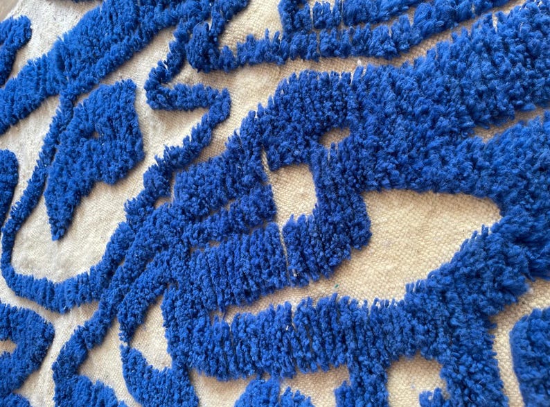 A vintage Moroccan wool rug with a bold blue abstract design handwoven on a neutral beige background, featuring plush texture and traditional fringed edges Vintage Rug, Moroccan Rug Wool Rug Abstract Rug Handwoven Rug Blue Rug Bold Design Modern Rug