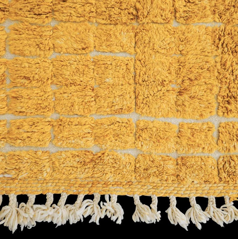 Soft peach Moroccan rug with light pink grid pattern, handcrafted by Berber artisans using 100% natural wool. Unique Boujad style with fluffy texture, ideal for cozy interiors, nurseries, boho bedrooms, and minimalist homes. Custom sizing available.