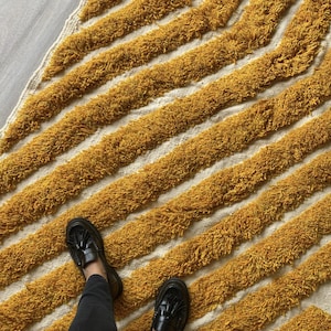 Yellow rug Handwoven rug Shaggy texture Moroccan style Geometric pattern Bohemian decor Cozy rug Soft texture Artisan rug Modern boho Statement piece Living room decor Bold design Striped rug Plush rug Warm tones Handmade rug Earthy colors Vintage