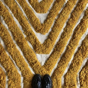 Yellow rug Handwoven rug Shaggy texture Moroccan style Geometric pattern Bohemian decor Cozy rug Soft texture Artisan rug Modern boho Statement piece Living room decor Bold design Striped rug Plush rug Warm tones Handmade rug Earthy colors Vintage