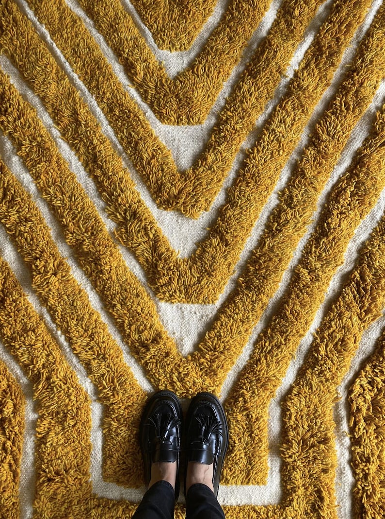 Yellow rug Handwoven rug Shaggy texture Moroccan style Geometric pattern Bohemian decor Cozy rug Soft texture Artisan rug Modern boho Statement piece Living room decor Bold design Striped rug Plush rug Warm tones Handmade rug Earthy colors Vintage