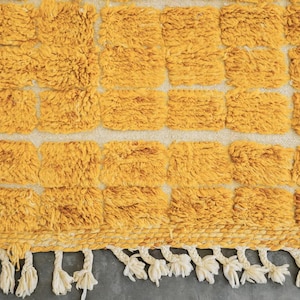 yellow wool rug, handwoven moroccan rug, textured area rug, boho home decor, cozy wool carpet, grid pattern rug, bohemian living room, mustard yellow rug, handmade bedroom rug, warm floor accent, boho wool carpet, minimalist area rug plush cozy decor