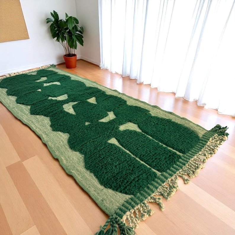 Extra-long Moroccan runner rug in deep green with bold organic patterns and beige wool base. This handcrafted Beni Ourain wool carpet is perfect for hallways, corridors, and modern interiors needing a unique, earthy touch. Made by Berber artisans using natural wool, it combines luxury softness and geometric structure. Ideal for minimalist, boho, or Japandi-style homes.