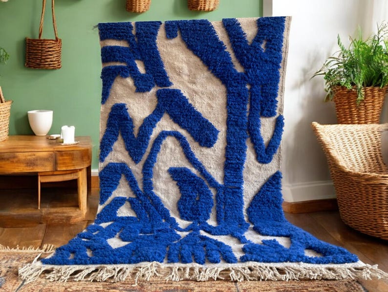 A vintage Moroccan wool rug with a bold blue abstract design handwoven on a neutral beige background, featuring plush texture and traditional fringed edges Vintage Rug, Moroccan Rug Wool Rug Abstract Rug Handwoven Rug Blue Rug Bold Design Modern Rug
