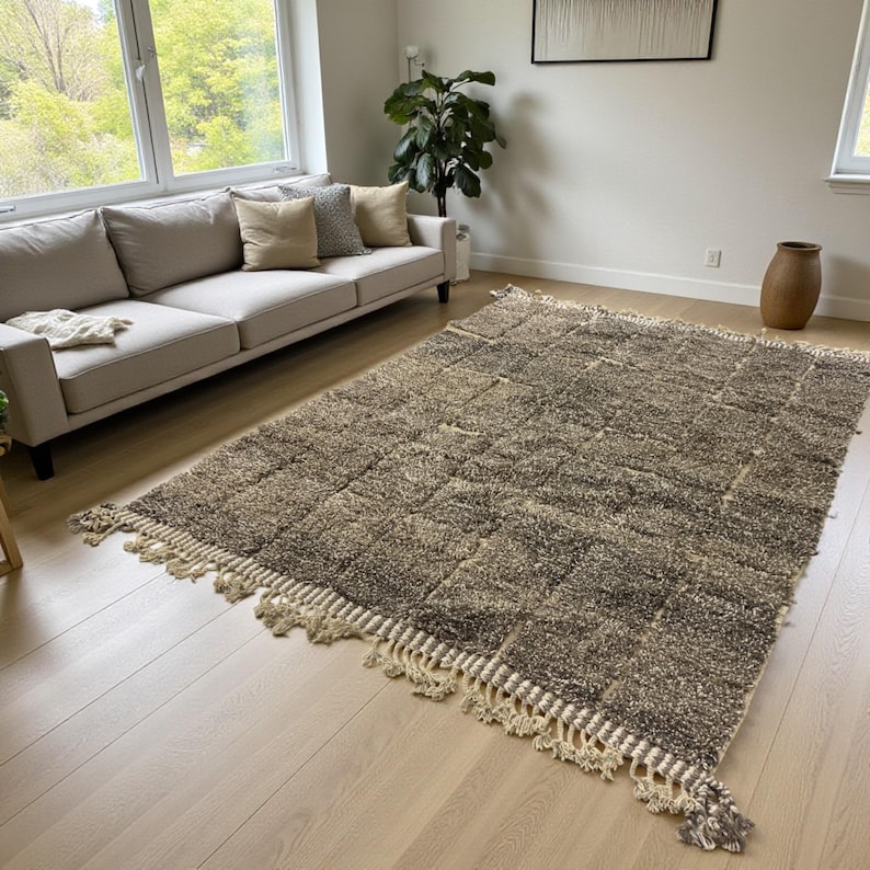 Handwoven Moroccan rug made from 100% natural wool in Travertine and White tones. Its rich texture and neutral color palette make it the perfect statement piece for modern, minimalist, or boho interiors. Crafted by Amazigh artisans in the Atlas Mountains, this rug combines traditional Moroccan weaving with a soft, earthy design. Ideal for living rooms, bedrooms, or cozy reading spaces, it brings warmth and timeless elegance to your home.
